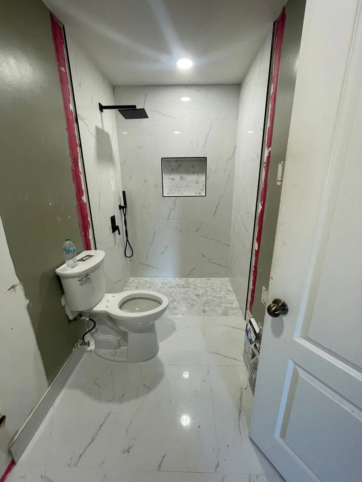 Marble-look tiled shower in a Broward County bathroom remodel by MGS