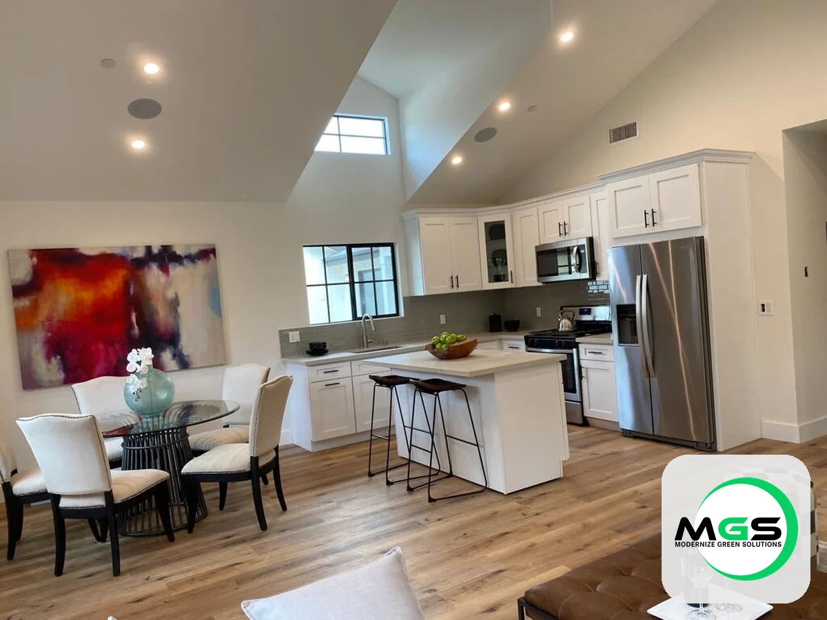 Open-concept kitchen and dining remodel with a vaulted ceiling by Modernize Green Solutions