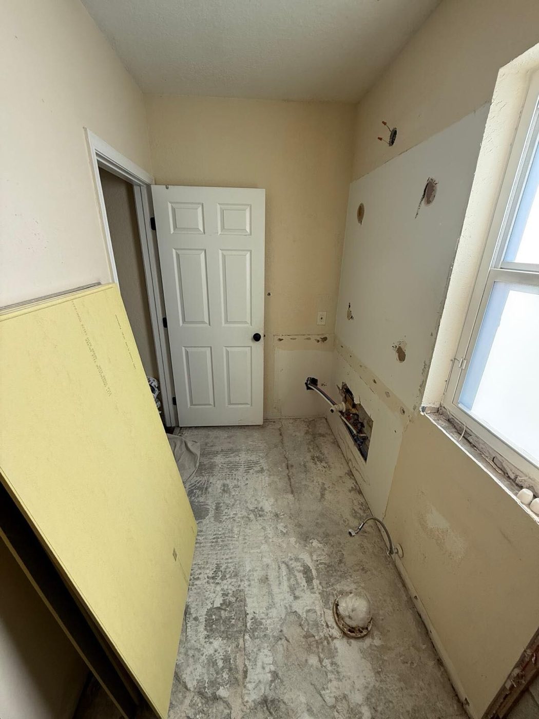 The room cleared back to bare floor before the new layout went in.