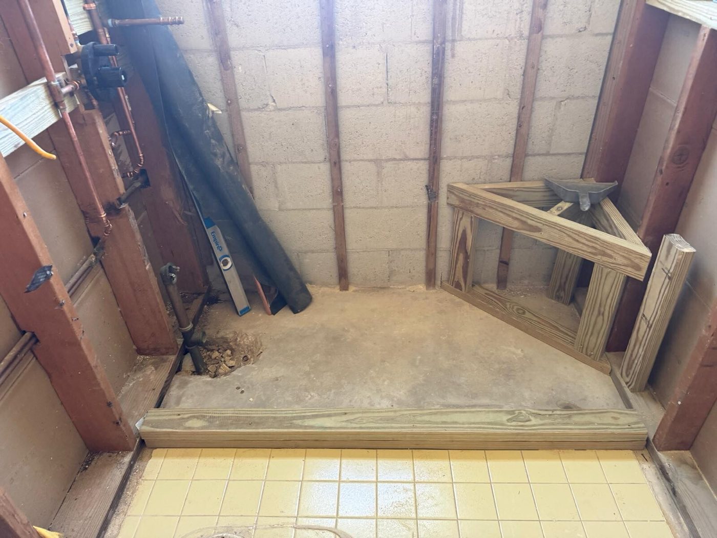 The old shower stripped back to block wall and framed base.