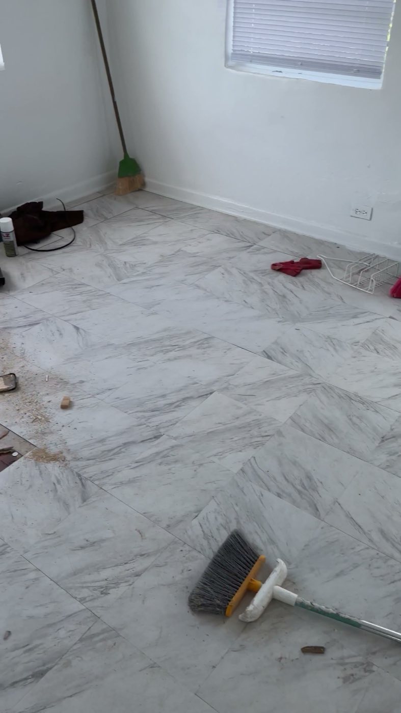 Before: the original white marble-look tile floor.