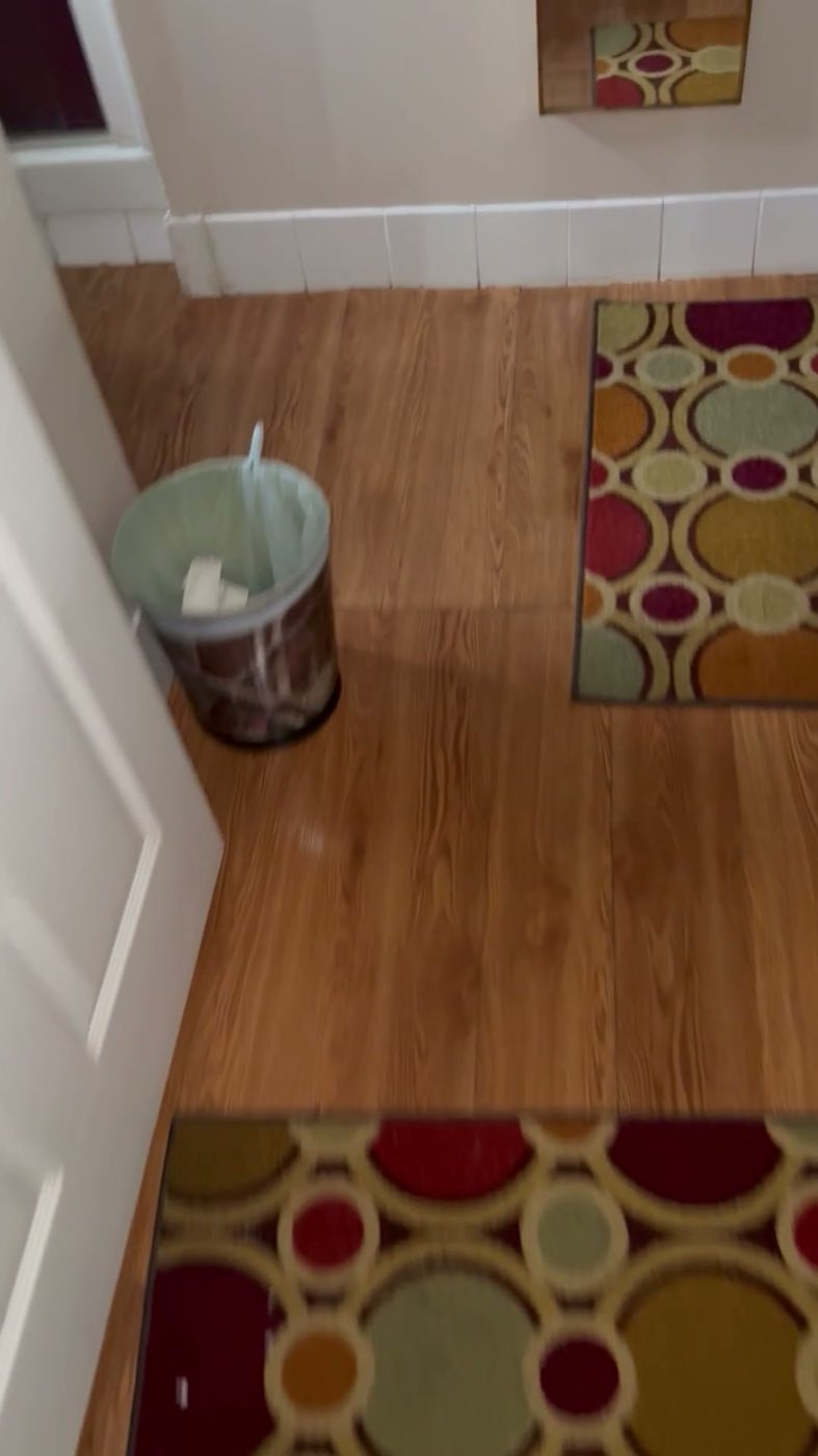 Before: the original honey-toned wood floor.