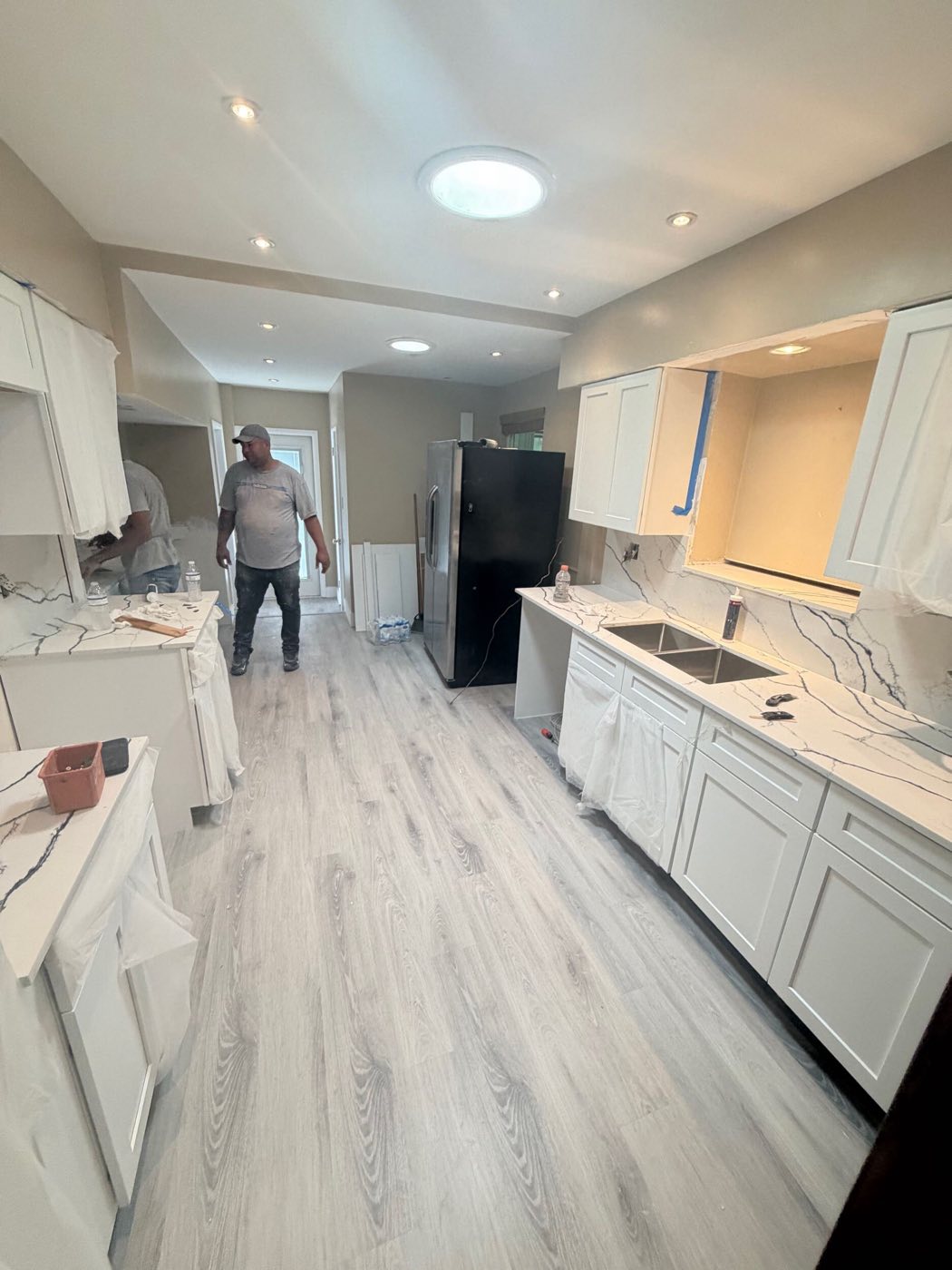 The finished kitchen: island, counters and new plank floor.