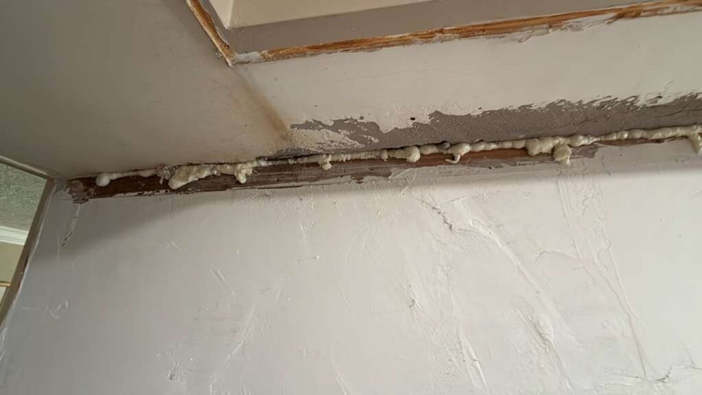 Spray foam sealing run along the opened ceiling line.