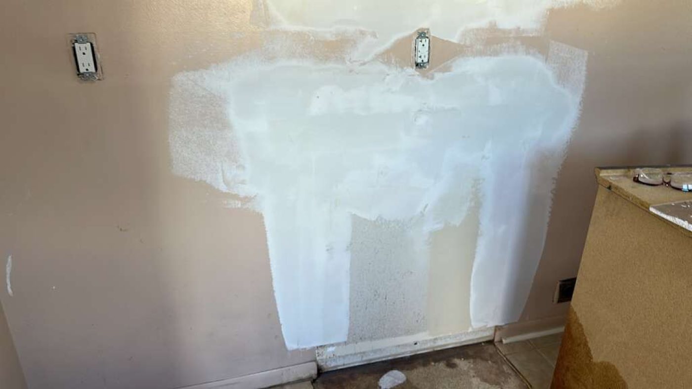 During demo: wall patched ahead of new cabinetry.