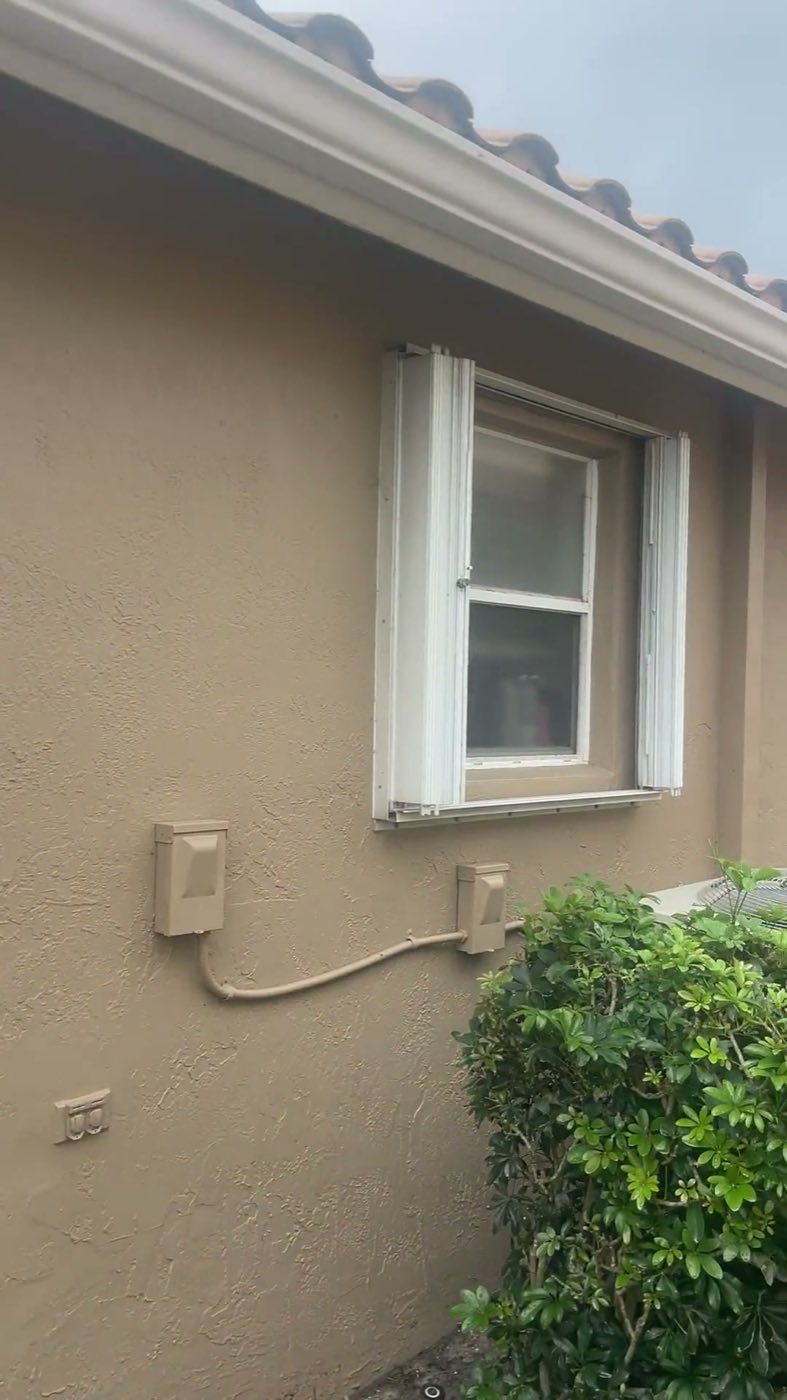 Before: an original white-framed window on the side wall.