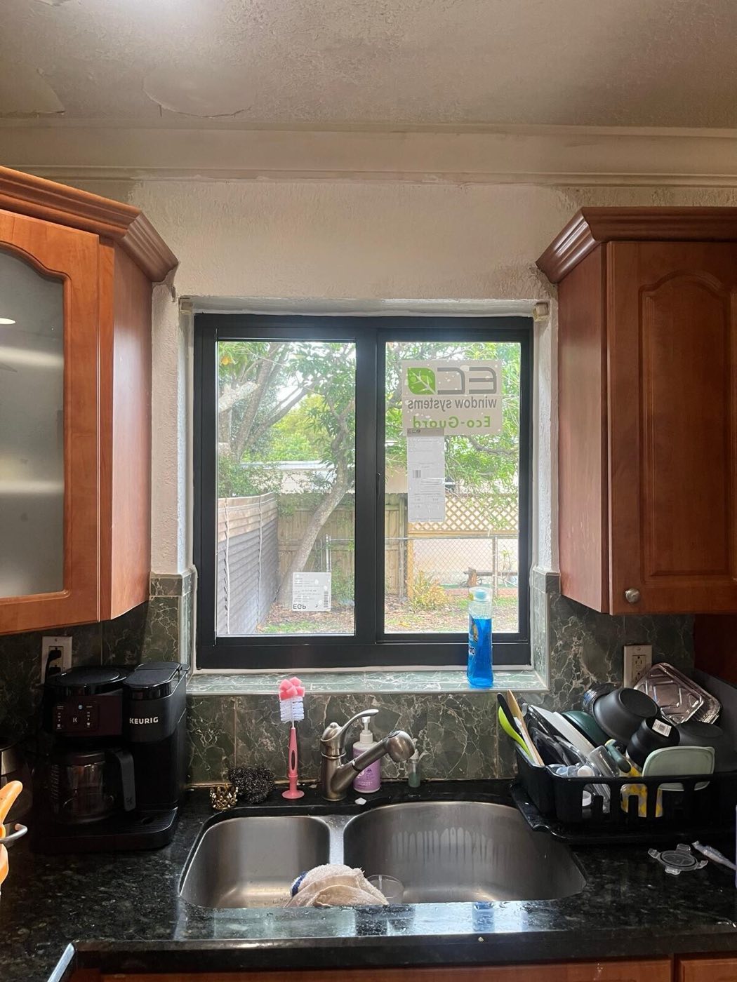 A new dark-framed window over the kitchen sink.