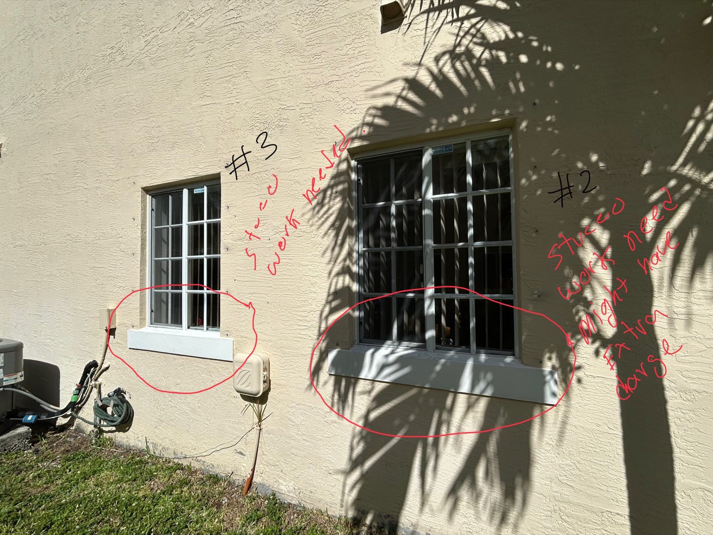 An opening circled and numbered in red survey marker, with install notes written on the wall.